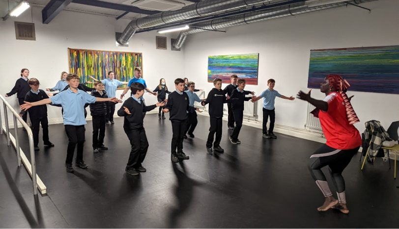 Figure 1: Aissatou dancing with pupils from Ysgol Gyfun Gwyr